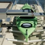 Bright green kayak secured on boat dock at Camp & Cruise.