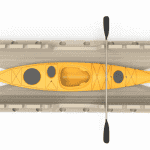 Bright yellow kayak with paddle inside storage racks at Camp & Cruise.