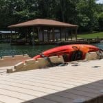 Kayak on dock at Camp & Cruise, ideal for water sports and outdoor activities.