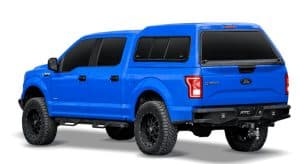 High-resolution image of a customized Ford F-150 pickup truck in bold blue color with off-road tires.