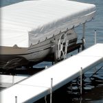 Alt text: White vinyl-decked boat dock with side-mounted posts on water.