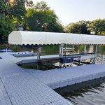 Premium floating dock with sun protection canopy for boating and watersports. Perfect for lakeside recreation.