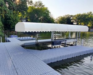 Premium floating dock with sun protection canopy for boating and watersports. Perfect for lakeside recreation.