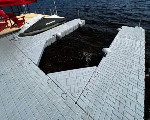 Floating dock with jet ski storage area on a serene lake. Durable, modular design perfect for waterfront recreation.