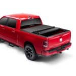 Red Dodge Ram truck with tonneau cover at Camp & Cruise.