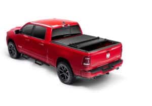 Red Dodge Ram truck with tonneau cover at Camp & Cruise.