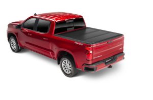 Red Chevrolet pickup truck with a black bed cover at Camp & Cruise.