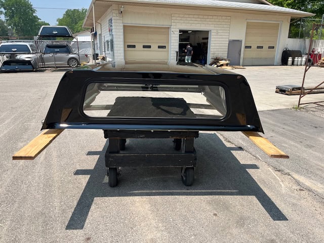 Black truck bed with wooden side panels for GMC 1500 70" PNT Code.