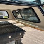 Close-up of truck cap interior with windows and storage area.