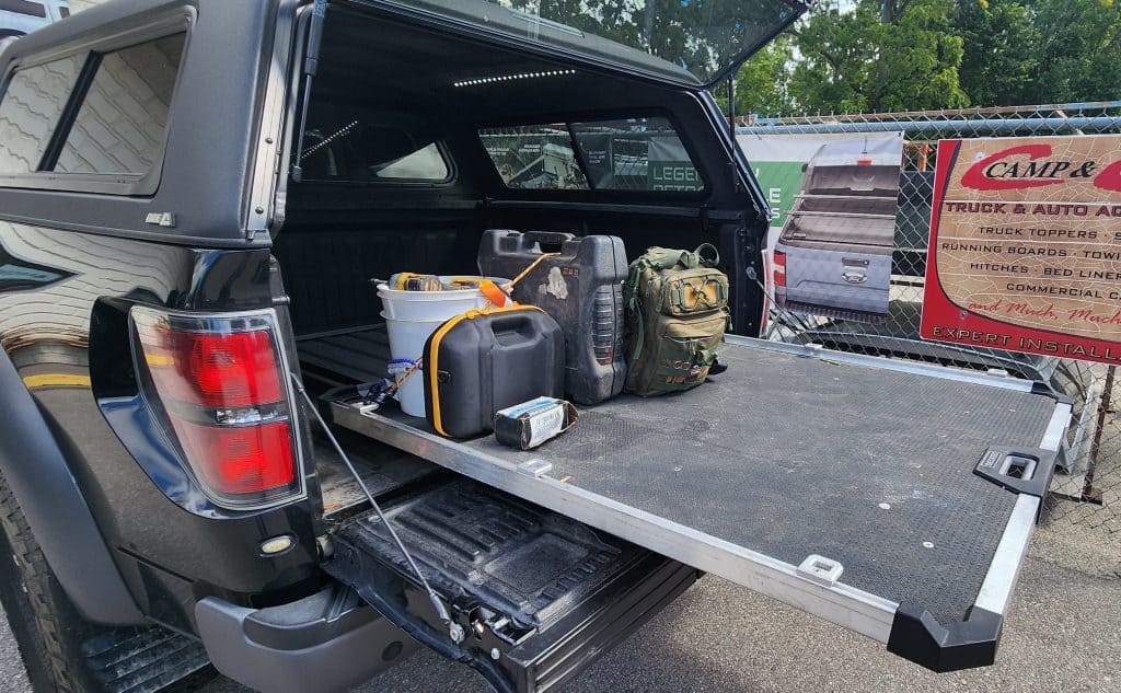 Truck bed with organized tools and gear for outdoor work or recreation.