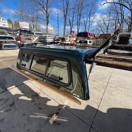 Green truck cap for Tundra 14-21 models with window and roof rack.