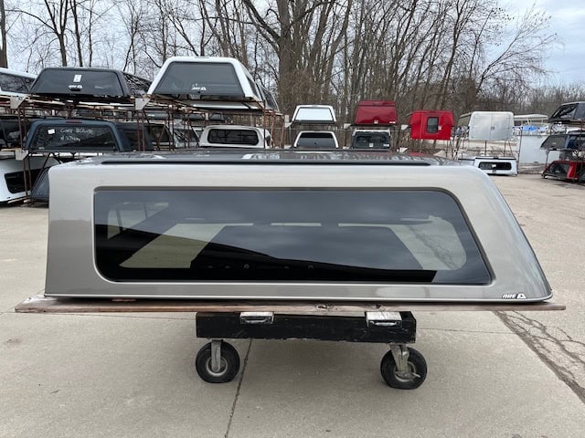 Gray GMC 1500 truck cap with tinted window for sale.