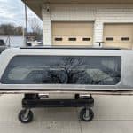 Gray GMC 1500 truck cap panel with tinted windows for demo.