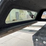 GMC 1500 truck bed cap with window and interior view.