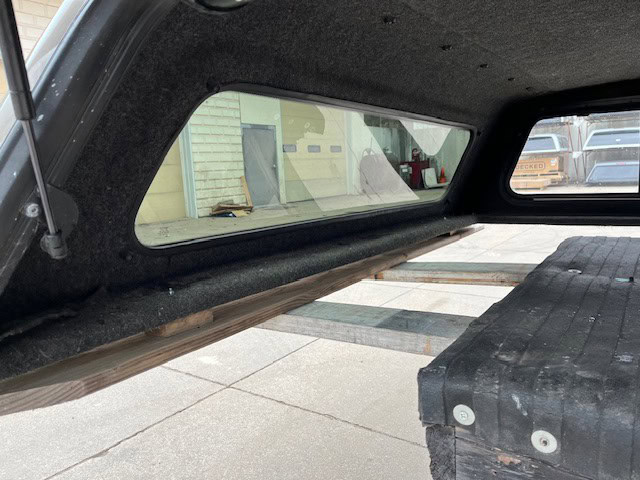 GMC 1500 truck bed cap with window and interior view.