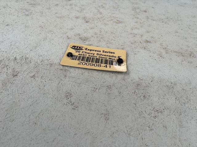 Chevy 1500 8' cap paint code label on truck bed surface.