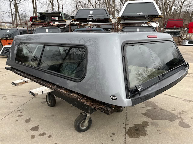 Gray truck cap with windows for Chevy 1500 8' bed.