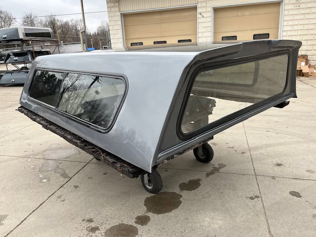 Gray truck cap with tinted windows for Chevy 1500 8' bed.