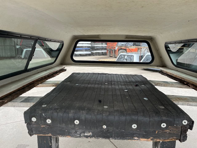 Interior view of Chevy 1500 truck cap with cargo area.