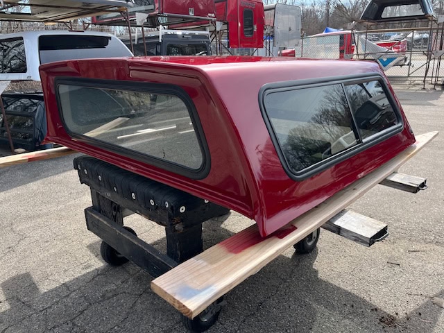 Red truck bed cap for Ford Ranger 60" with tinted windows.