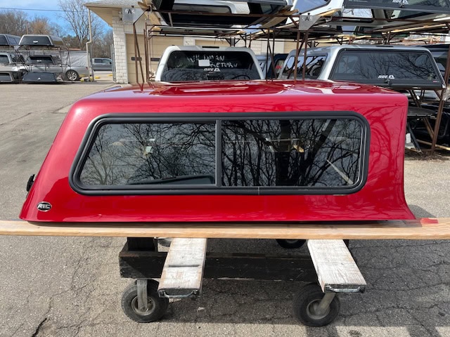 Red Ford Ranger 60-inch truck cap with tinted window for sale.