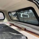 Red Ford Ranger 60-inch truck cap with tinted windows inside the vehicle.