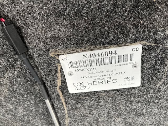 Truck bed cover with serial number label for Chevy 1500.