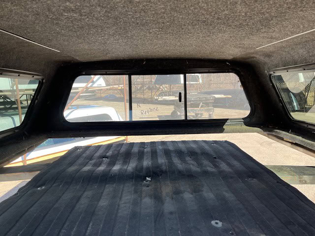 Black truck bed cover for Chevy 1500 with all-season protection.