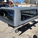 Gray truck bed cap with tinted windows for RAM 1500.