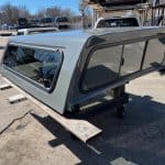 Gray truck cap with tinted windows for RAM 1500, 76" body, ceramic gray color.