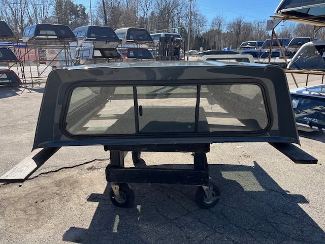 Gray truck cap with tinted windows for RAM 1500 76" body.