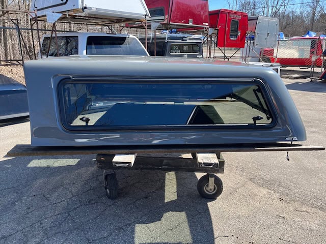 Gray truck cap with tinted window for RAM 1500 76" bed.