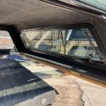 Truck bed cover with rear window and cargo area for RAM 1500.