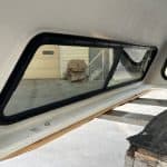 Side truck window with black frame and tinted glass for Chevy HD.
