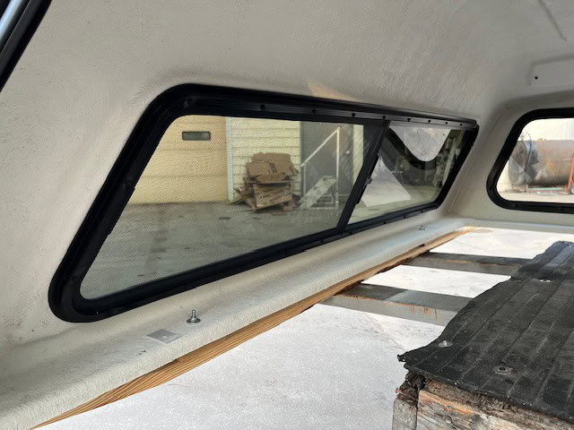 Side truck window with black frame and tinted glass for Chevy HD.