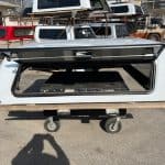 White truck cap with tinted window for RAM 1500, outdoor storage solution.
