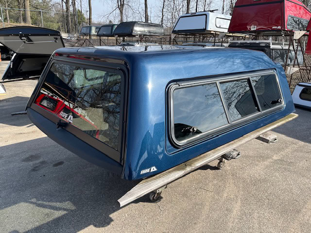 Northsky blue truck cap for Chevy 1500 with side windows and aerodynamic design.