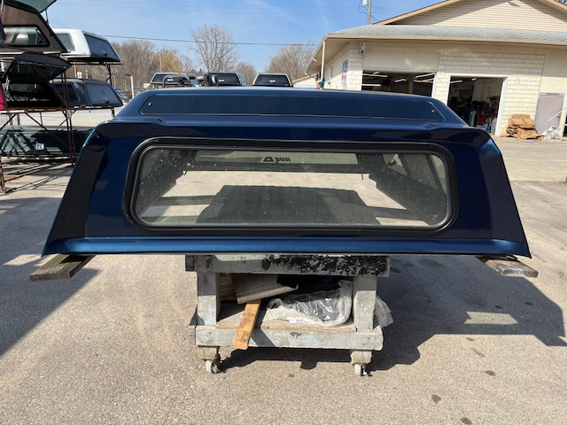 Northsky blue truck cap for Chevy 1500 with rear window and aerodynamic design.