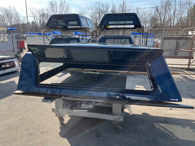 Northsky blue truck cap for Chevy 1500 with tinted windows and aerodynamic design.