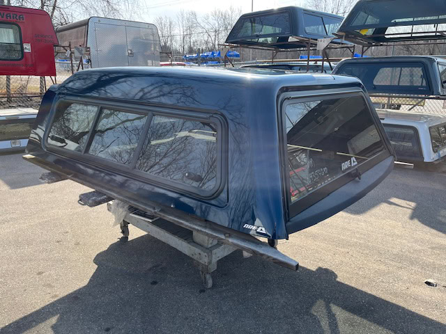 Northsky Blue truck cap for Chevy 1500 with tinted windows and aerodynamic design.