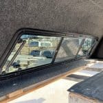 Interior view of Chevy 1500 with Northsky Blue cap and side window.