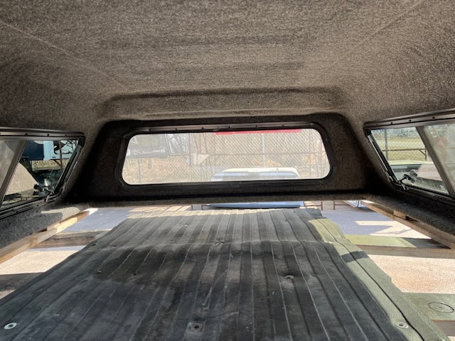 Interior view of Chevy 1500 truck with Northsky Blue cap and cargo area.