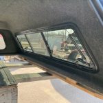 Truck cap window with tinted glass and black frame for Chevy 1500.