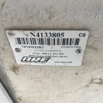 Close-up of GMC 1500 cap paint code label with serial number and barcode.