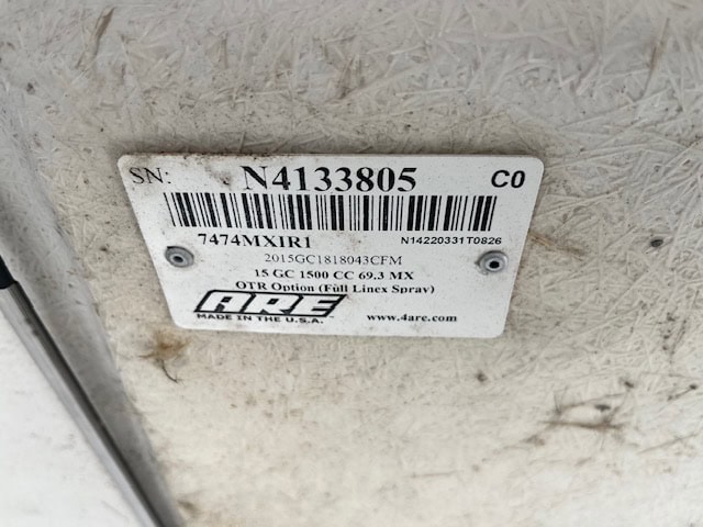 Close-up of GMC 1500 cap paint code label with serial number and barcode.