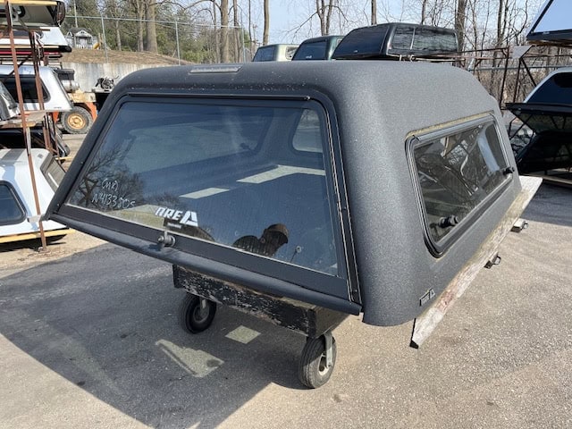 Gray truck cap for GMC 1500 with side windows and rear window.