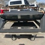 GMC 1500 truck cap in gray with open rear window for sale.