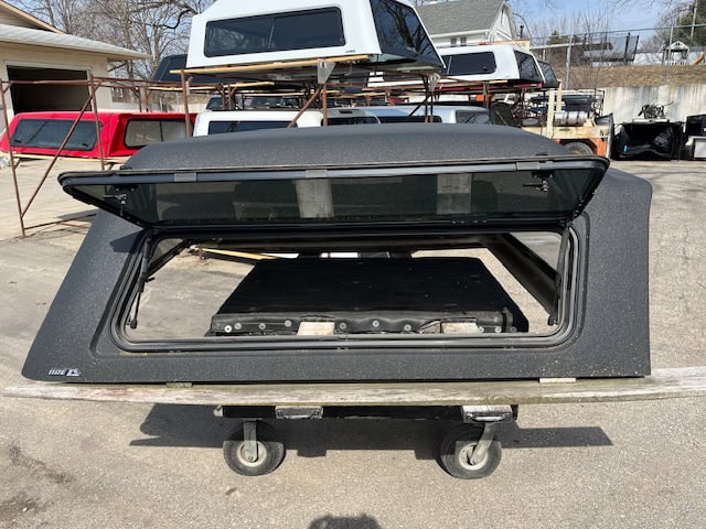 GMC 1500 truck cap in gray with open rear window for sale.