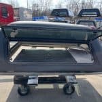 Gray truck cap for GMC 1500 with tinted window and lockable side access.