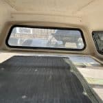 GMC 1500 truck bed cap with rear window and side windows.